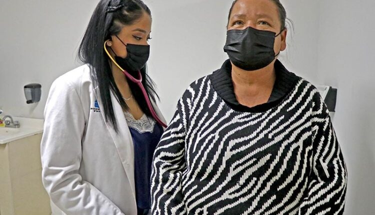 Mujer siendo atendida por una doctora en un centro de salud.