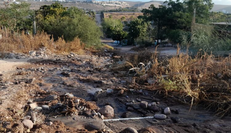 calle de terracería afectada por fuga de agua